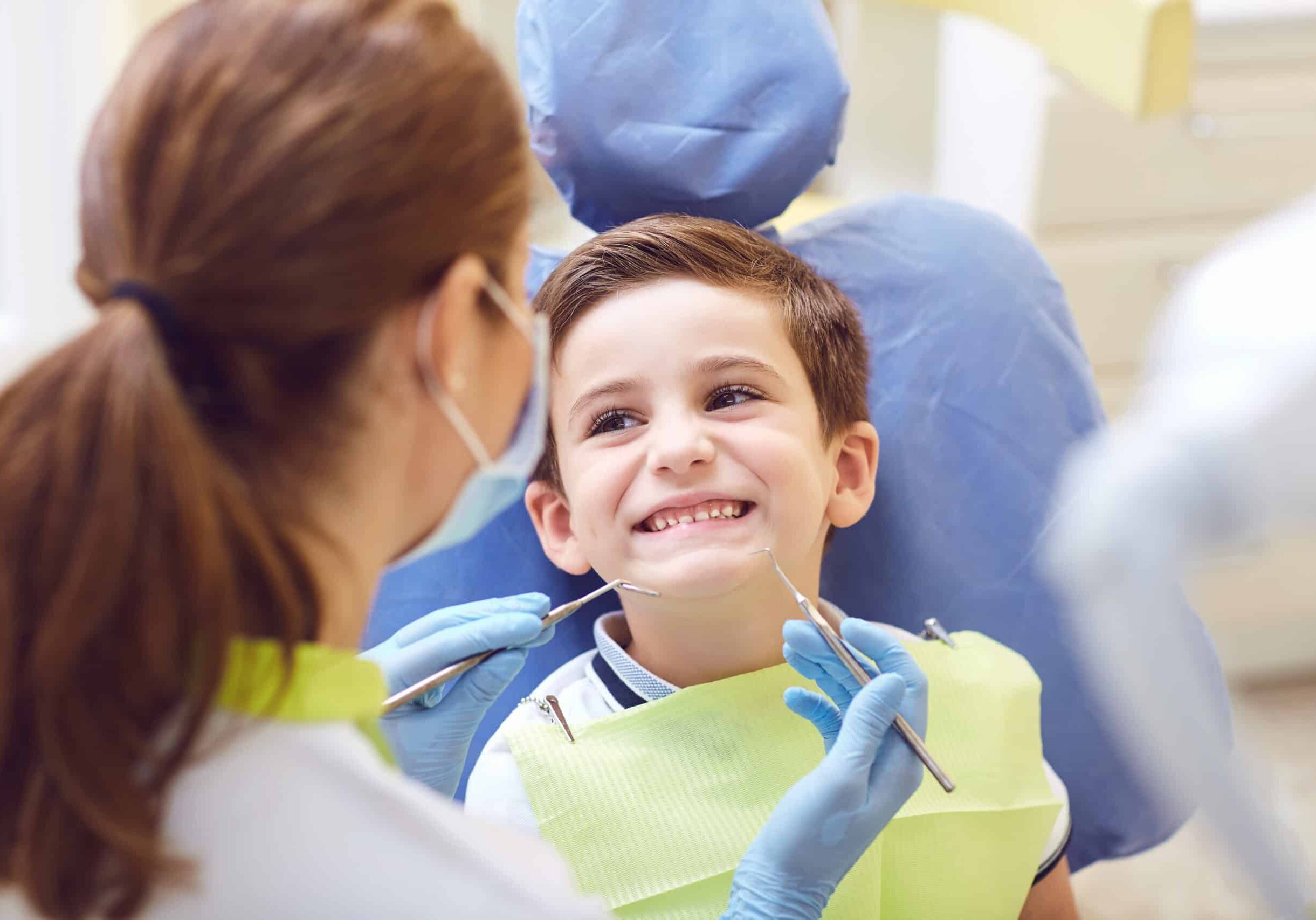 A child with a dentist in a dental office. A child with a dentist in a dental office. Dental treatment in a children's clinic.